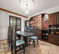 Dining room with wooden furniture and decorative elements in a family house.