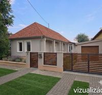A family house in Kokšov-Bakša with a terracotta roof and a garden behind the gate.