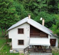 A cottage in the Šugovská Valley in Medzev, surrounded by forests and green trees.