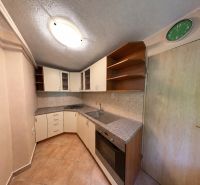 Cottage kitchen with a kitchen unit and a wooden decor floor.