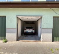 A car parked in a garage between buildings in Kežmarok.