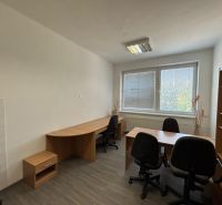 Offices with wood-patterned flooring, desks, and office chairs.