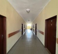 A corridor with tiles and wooden paneling in the interior of offices.