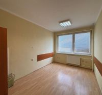 An office with large windows, wooden decor flooring, central heating.
