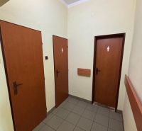 Offices with three marked doors and tiled flooring.