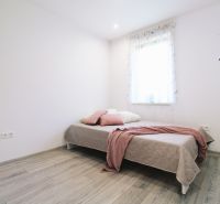 Children's room with a bed and a wooden decor floor in a family house.