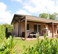 A family house in Bytča with a garden, terrace, and covered seating area in a sunny environment.