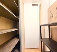 Storage space with shelves and hooks in a 2-room apartment.