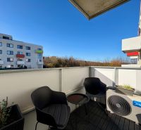 The balcony of a 2-room apartment on Hornostavska Street in Nitra, with modern seating and greenery.