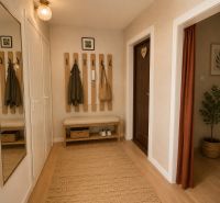 A hallway in a 2-room apartment with coat racks, a bench, a mirror, and a floor with a wooden decor.