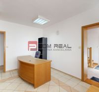 Interior of production facilities with an office desk and tiled flooring.