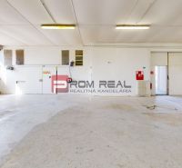 Bright production spaces with large windows and white walls.