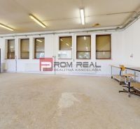 Production facilities with concrete flooring, tables, and lighting for workshop activities.