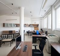 Offices with wooden decor furniture, desks, and computers.