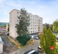 Apartment building surrounded by greenery, Zvolen, Bela IV Street, with parked cars.