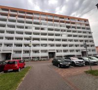 Apartment building on Dušan Madačov Street in Ružomberok with a parking lot and cars in front of a 3-room apartment.