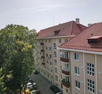 An apartment building on Sad kpt. Nálepku in Nová Dubnica surrounded by trees.