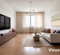 Living room in a 2-room apartment with a sofa, television, and wooden decor flooring.
