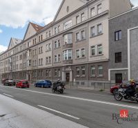 Palackého Street in Košice-Juh with historic buildings, cars, and a motorcyclist.