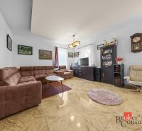 Living room in a family house with a comfortable sofa and paintings on the walls.