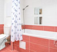 Bathroom in a 3-room apartment with a bathtub, sink, and shower curtain with anchors.