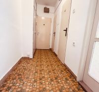 Hallway in a 2-room apartment with tiles and white walls.