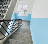 The staircase of the apartment building with a blue wall and railing on Petőfi Street, Nové Zámky.