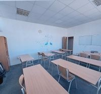 Classroom with desks, chalkboard, and wall decoration in the Offices.