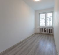 An empty room with a wood-patterned floor in a 3-room apartment.