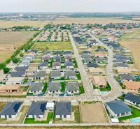 Aerial view of a residential area near the South Gate in Senec with visible houses and roads.