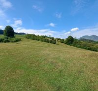 Grassy meadows and hills near the cottage on Do Žlebín Street in Ružomberok.
