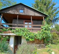 A cottage in Do Žlebín in Ružomberok surrounded by greenery and vineyards.