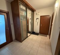 The entrance hallway of a 3-room apartment with tiles and a wardrobe.