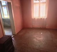A room with old furniture and pink walls in a family house.