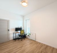 A study with a writing desk, chair, and floor with a wooden decor in a 4-room apartment.
