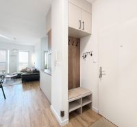 Interior of a 4-room apartment with a wooden decor floor and comfortable seating.