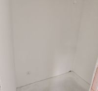 Pantry in a 3-room apartment with white walls and a socket on the wall.