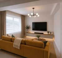 Living room in a 3-room apartment with a yellow sofa, television, and decorations.