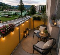 The balcony of a 3-room apartment on Školská Street in Hriňová, evening lighting, flowers, and candles.