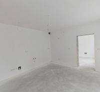 A spacious room in a 3-room apartment with white walls and preparation for electrical installations.