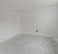 An empty room in a 3-room apartment with walls ready for painting.