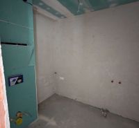 A partially finished room in a 2-room apartment with preparations for installations.