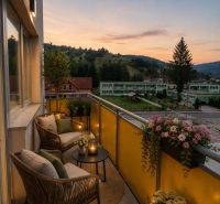 The balcony of a 2-room apartment on Školská Street in Hriňová with a view of nature at sunset.