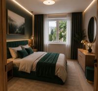 Bedroom in a two-room apartment with a bed, carpet, and wooden decor flooring.
