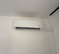 Air conditioning installed in a 3-room apartment, temperature display on the screen.