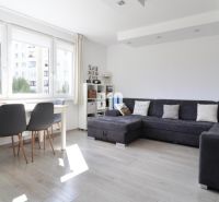 Living room, gray sofa, dining table, wooden decor flooring, 3-room apartment.
