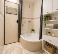 A bathroom with a shower, white furniture, and decoration in a 3-room apartment.