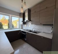 A kitchen in a family house with a view of the garden and modern kitchen appliances.