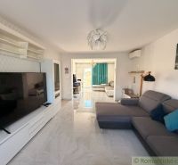 Living room in a family house with a sofa, television, and spacious layout.