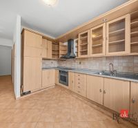 A kitchen with wooden decor, built-in appliances, and tiles in a 2-room apartment.